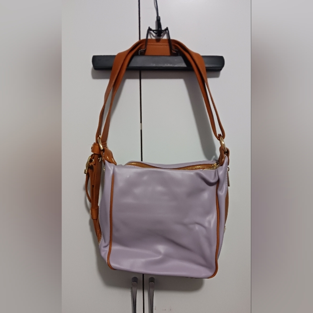 Light purple leather crossbody shoulder /backpack  with brown leather straps